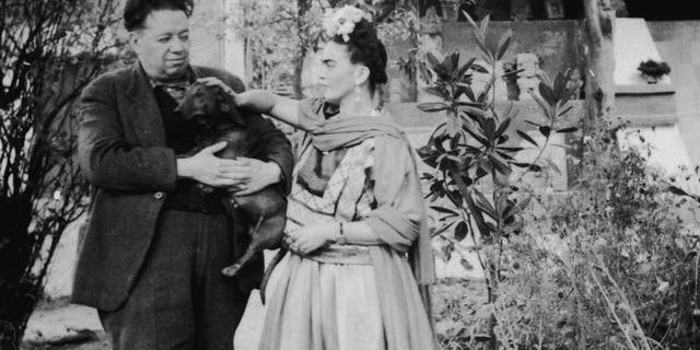Frida Kahlo and Diego Rivera with a pet dog in Mexico City, Mexico, 1940s.