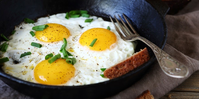 Hot fried eggs in a pan, close up