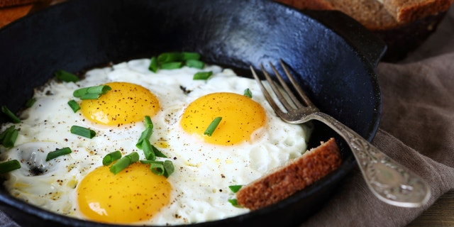 Hot fried eggs in a pan, close up
