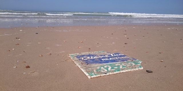 A damaged sign blown away from the Jersey Shore during Hurricane Sandy in 2012. The sign ultimately washed up on a French beach.