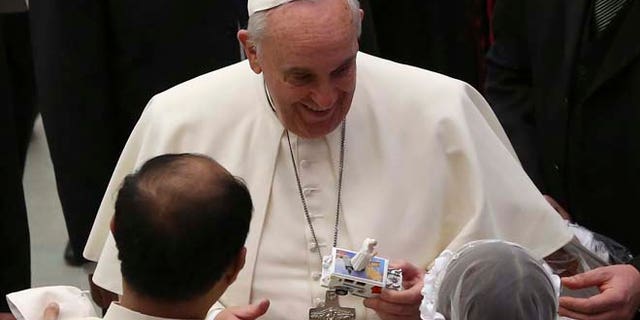 Jan. 28: Pope Francis receives a toy of himself as he leads his Wednesday general audience in Paul VI hall at the Vatican.