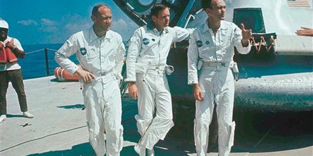 **ADVANCE FOR THURSDAY, JULY 16** FILE - In this 1969 file photo, Apollo 11 astronauts stand next to their spacecraft in 1969, from left to right: Col. Edwin E. Aldrin, lunar module pilot; Neil Armstrong, flight commander; and Lt. Michael Collins, command module pilot. (AP Photo, file)
