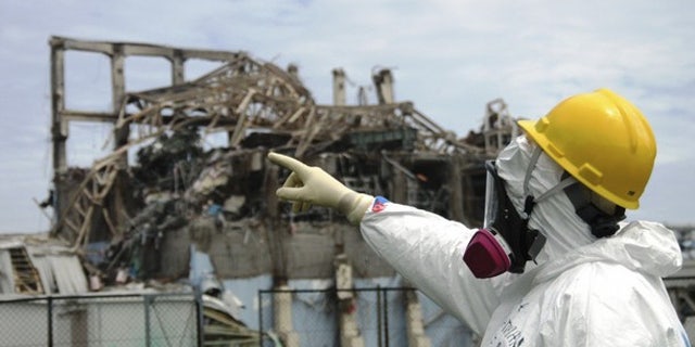 International Atomic Energy Agency (IAEA) fact-finding team leader Mike Weightman examines the No. 3 reactor at the Fukushima Daiichi Nuclear Power Plant. Radioactive sulfur from the disaster reached California, according to researchers.