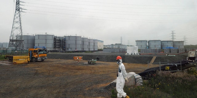 June 12, 2013: In this file photo, a construction worker walks beside the underground water tanks at the Fukushima Dai-ichi nuclear plant at Okuma in Fukushima prefecture, Japan. The operator of Japan's tsunami-crippled nuclear power plant said Tuesday, Aug. 20, 2013, that about 300 tons of highly radioactive water have leaked from one of the hundreds of storage tanks there - its worst leak yet from one of the vessels.