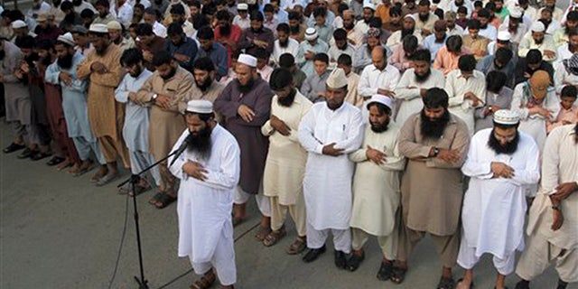 Supporters of a Pakistani religious group, "Jamaat-ud-Dawa," offer funeral prayers for Taliban leader Mullah Mohammad Omar outside a mosque in Karachi, Pakistan, Sunday, Aug. 2, 2015.