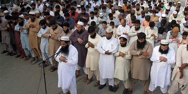 Supporters of a Pakistani religious group, "Jamaat-ud-Dawa," offer funeral prayers for Taliban leader Mullah Mohammad Omar outside a mosque in Karachi, Pakistan, Sunday, Aug. 2, 2015.