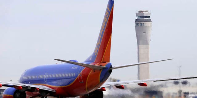 This photo taken April 23, 2013 shows a Southwest airlines jet waiting to depart in view of the air traffic control tower at Seattle-Tacoma International Airport in Seattle.