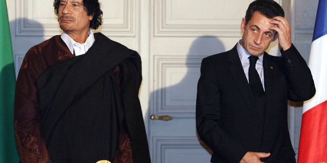 Libyan leader Col. Moammar Gadhafi, left, and French President Nicolas Sarkozy, pose during a signing ceremony at the Elysee Palace in Paris, Dec. 10, 2007.