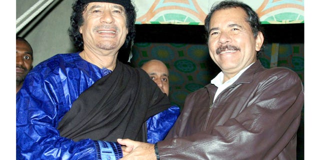 In this handout photo released by Presidential House of Nicaragua, Libyan leader Moammar Gadhafi, left, shakes hands with Nicaragua's President Daniel Ortega during a meeting in Tripoli, Libya, Tuesday, June 5, 2007.(AP Photo/Presidential House of Nicaragua/Jairo Cajina) ** NO SALES **
