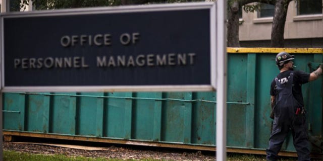 In this Thursday, Oct. 17, 2013 photo, a worker is seen at the Office of Personnel Management in Washington.