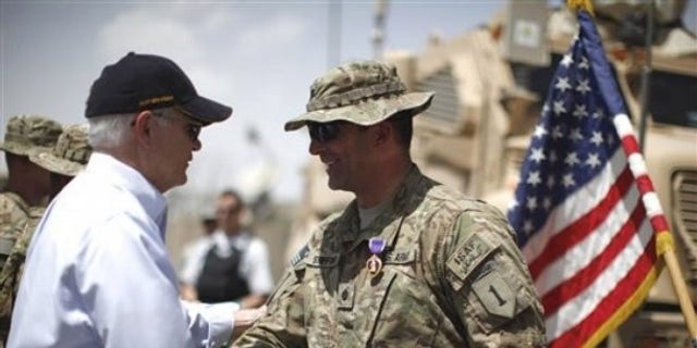 June 6: Defense Secretary Robert Gates shakes hands with U.S. Army LtCol. Alan Streeter after awarding him the Purple Heart Medal for wounds he received in combat during a ceremony at Combat Outpost Andar in Ghazni Province, Afghanistan.