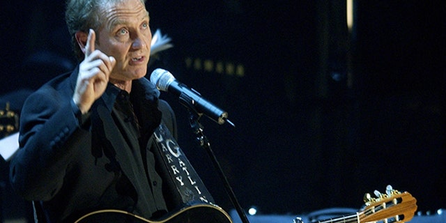 Country music artist Larry Gatlin points to heaven after singing "Diamonds
In The Rough," during a tribute to the late country music legend Johnny
Cash, at the Ryman Auditorium in Nashville, Tennessee, late November 10,
2003. Cash died September 12, 2003, at the age of 71 from complications from
diabetes. REUTERS/John Sommers II