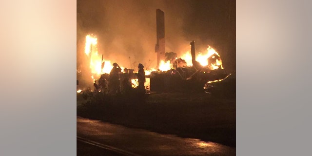 Firefighters stand by a destroyed home in Tennessee.