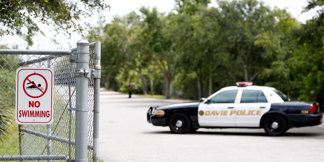 Police block the entrance to Silver Lakes Rotary Nature Park on Friday.