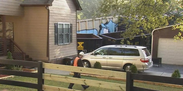 An Atlanta resident was injured when a freight train derailed and struck his home.