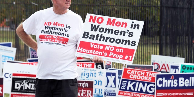 FILE -- Oct. 21, 2015: A man urges people to vote against the Houston Equal Rights Ordinance outside an early voting center in Houston. (AP Photo/Pat Sullivan)