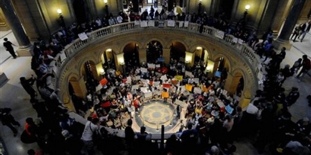 May 21: Demonstrators shout and wave signs in the State Capitol rotunda during a Peoples Rally for a Fair Minnesota as the state Legislature debated gay marriage near the end of its session.