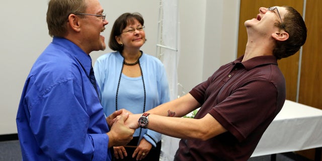 June 26, 2014: Adam Shoffner, right, shouts his joy after he married Daniel Tolliver, left, as Marion County Clerk Beth White looks on as same sex couple continued to be married for the second day in Indianapolis.