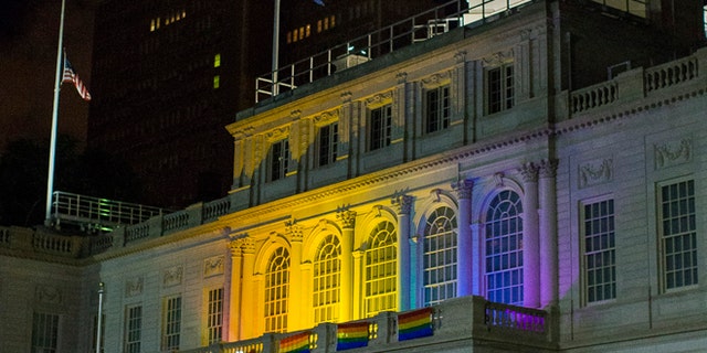 June 12, 2016: The New York City Hall building is illuminated in the colors of the LGBT pride flag in honor of the victims of the mass shooting in Orlando, Florida, in New York.