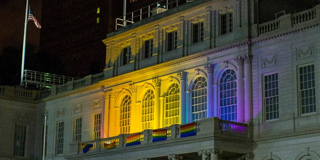 June 12, 2016: The New York City Hall building is illuminated in the colors of the LGBT pride flag in honor of the victims of the mass shooting in Orlando, Florida, in New York.