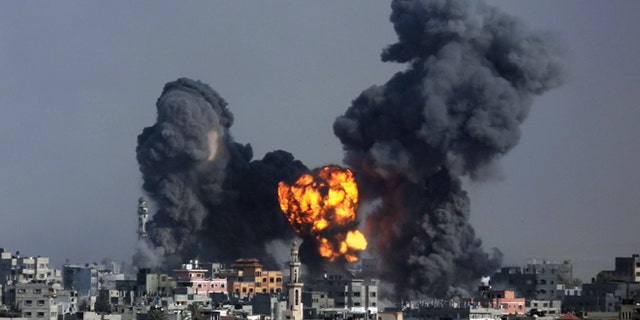 July 22, 2014: Smoke and fire from the explosion of an Israeli strike rise over Gaza City.
