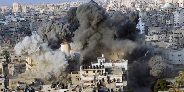 An Israeli airstrike hits the Said al-Mis'hal cultural center in Gaza City Thursday.