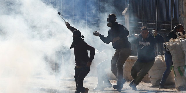 Palestinians clash with Israeli troops during a protest against President Trump's decision to recognize Jerusalem as the capital of Israel.
