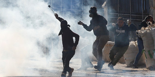 Palestinians clash with Israeli troops during a protest against President Trump's decision to recognize Jerusalem as the capital of Israel.