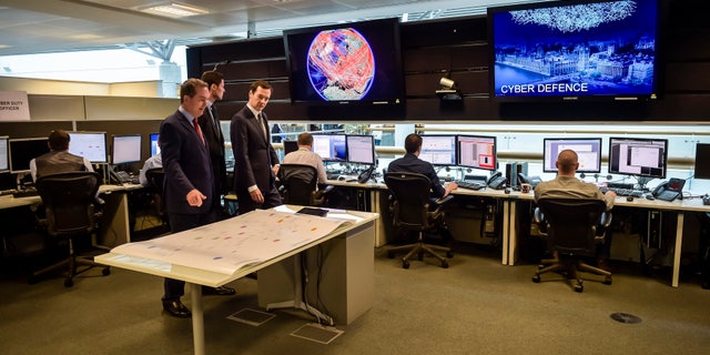 Britain's Chancellor of the Exchequer George Osborne is shown the 24 hour Operations Room inside GCHQ, by the Director of GCHQ Robert Hannigan (C) and Cheltenham MP Alex Chalk (L), in Cheltenham November 17, 2015. (REUTERS/Ben Birchall/Pool)