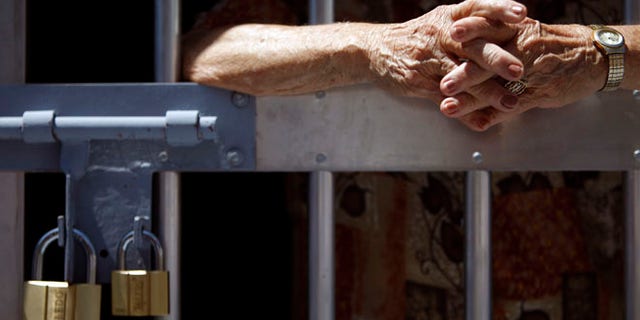 May 29, 2013: Unidentified man stands behind prison bars.