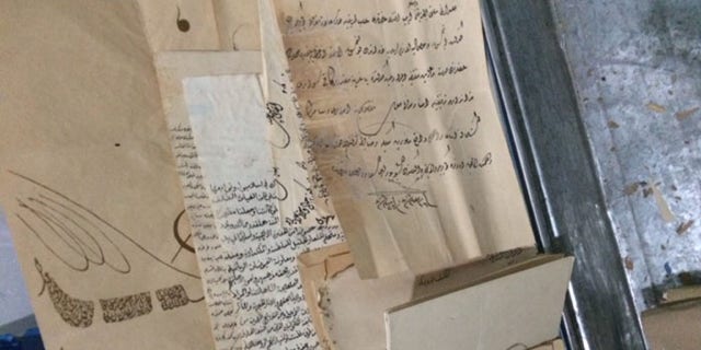 Christians now store priceless, ancient biblical scripts like these in the abandoned buildings where they live.