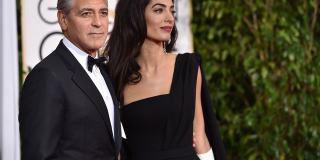 George Clooney, left, and Amal Clooney arrive at the 72nd annual Golden Globe Awards at the Beverly Hilton Hotel on Sunday, Jan. 11, 2015, in Beverly Hills, Calif.