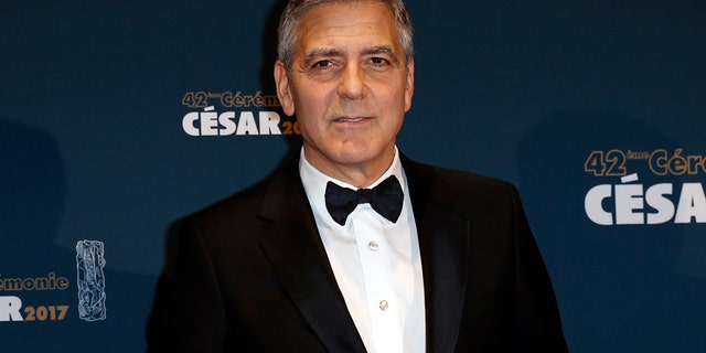 Actor George Clooney holds his trophy during a photocall after receiving an Honorary Cesar Award at the 42nd Cesar Awards ceremony in Paris, France, February 24, 2017.