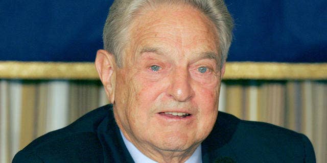 Billionaire financier and philanthropist George Soros speaks to reporters at the Foreign Correspondents' Club of Japan in Tokyo Monday, Oct. 16, 2006. Soros said that China should allow its currency to appreciate in order to maintain economic stability. Shown at right on the table is a copy of the Japanese version of his latest book "The Age of Fallibility." (AP Photo/Koji Sasahara)