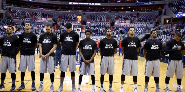 Dec. 10, 2014: Members of the Georgetown basketball team stand for the National Anthem wearing "I Can't Breathe" t-shirts before an NCAA college basketball game against Kansas,