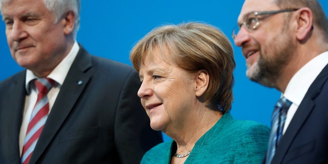 Christian Democratic Union leader and German Chancellor Angela Merkel, Christian Social Union leader Horst Seehofer and Social Democratic Party leader Martin Schulz pose after a statement in Berlin, Germany, Feb. 7, 2018.