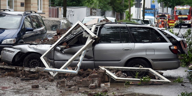 A car is destroyed after an explosion of a house in Wuppertal, Germany, June 24, 2018.