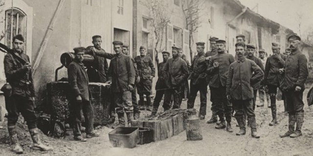 Captured German prisoners draw water from a well for their mess hall in Pierrefitte-sur-Aire, France.