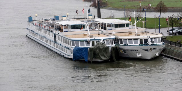 A tourist ship, left, is tied up at another ship in Duisburg, Germany, Wednesday, Dec. 27, 2017.