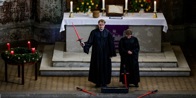 December 20, 2015. Vicars Lucas Ludewig, left, and Ulrike Garve, right, celebrate a Star Wars themed church service, at the Zion Church in Berlin, Germany.