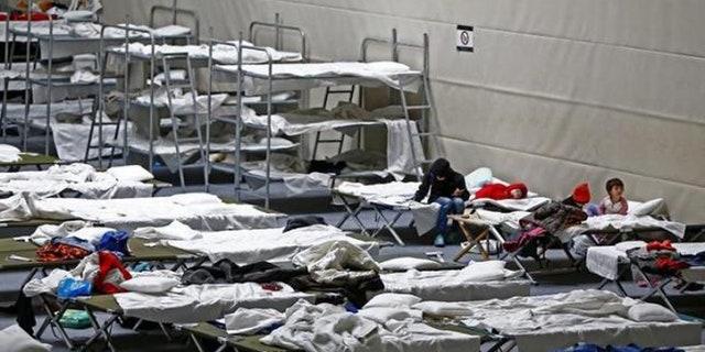 Refugees rest on beds at an improvised temporary shelter in a sports hall in Hanau, Germany, last month. (Reuters)