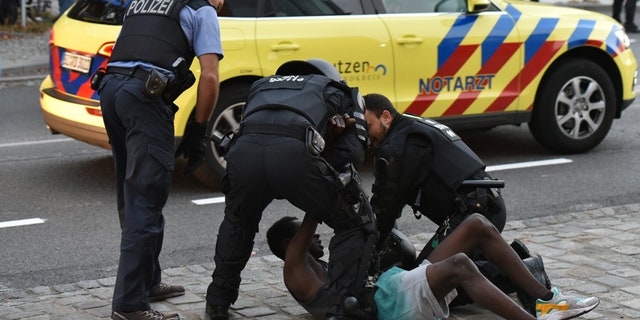 Sept. 10, 2016: Police officers take a man into custody during a gathering on a square at the Kornmarkt in Bautzen, Germany.