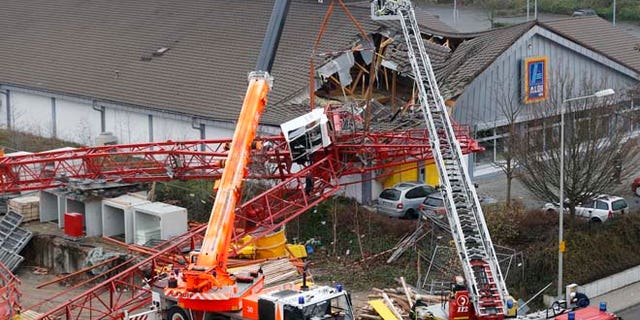 Dec. 11, 2013: A crane from a construction site has crashed into the roof of a supermarket in Bad Homburg, Germany.