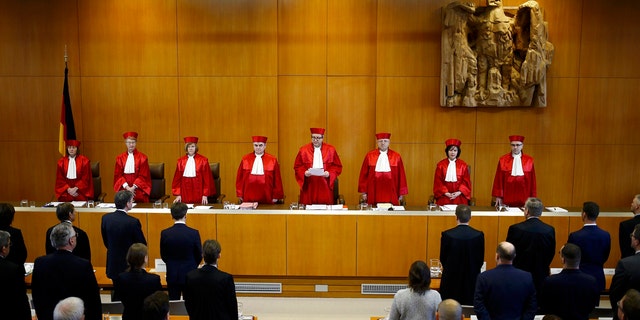 The judges of the German Constitutional Court, from left, Christine Langenfeld, Doris Koenig, Monika Hermanns, Peter Mueller, presiding judge Andreas Vosskuhle, Peter M. Huber, Sibylle Kessal-Wulf and Ulrich Maidowski announce that they rejected a bid of banning the far-right NPD party in Karlsruhe, southern Germany, Tuesday, Jan. 17, 2017. (Kai Pfaffenbach/Pool Photo via AP)