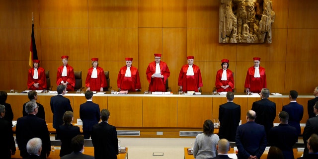 The judges of the German Constitutional Court, from left, Christine Langenfeld, Doris Koenig, Monika Hermanns, Peter Mueller, presiding judge Andreas Vosskuhle, Peter M. Huber, Sibylle Kessal-Wulf and Ulrich Maidowski announce that they rejected a bid of banning the far-right NPD party in Karlsruhe, southern Germany, Tuesday, Jan. 17, 2017. (Kai Pfaffenbach/Pool Photo via AP)