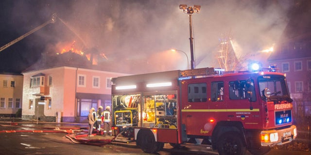 Feb. 21, 2016: A fire engine stands in front of a burning building in Bautzen, eastern Germany. The fire damaged a former hotel that was being converted into a refugee home and two people were detained after hindering firefighters work, police said (Rico Loeb/dpa via AP)