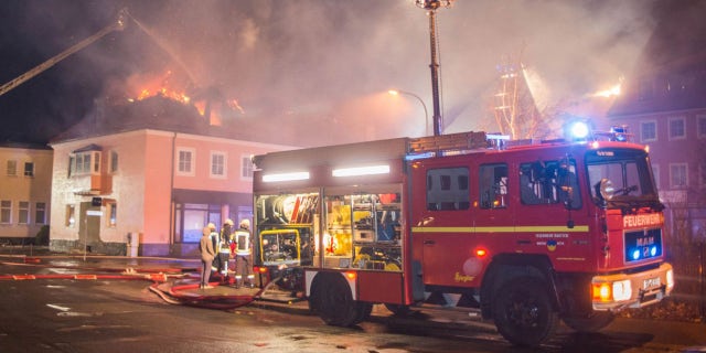Feb. 21, 2016: A fire engine stands in front of a burning building in Bautzen, eastern Germany. The fire damaged a former hotel that was being converted into a refugee home and two people were detained after hindering firefighters work, police said (Rico Loeb/dpa via AP)