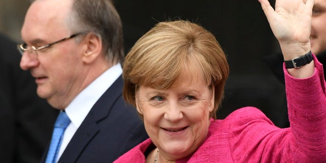 German Chancellor Angela Merkel attends celebrations for the 500th anniversary of the Reformation in front of the grave of Martin Luther at the Castle Church in Wittenberg, Germany, Tuesday, Oct. 31, 2017.