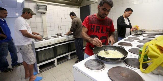 March 24, 2016: Migrants cook in the kitchen of the accommodation for migrants "Spree Hotel" in Bautzen, Germany.