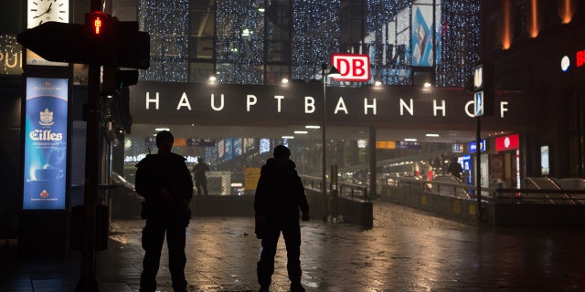 German special police stand in front of the Munich, southern Germany, main train station Thursday evening, Dec. 31, 2015 after police warned of 'imminent threat' of terror attack and ordered two train stations to be cleared. (Sven Hoppe/dpa via AP)